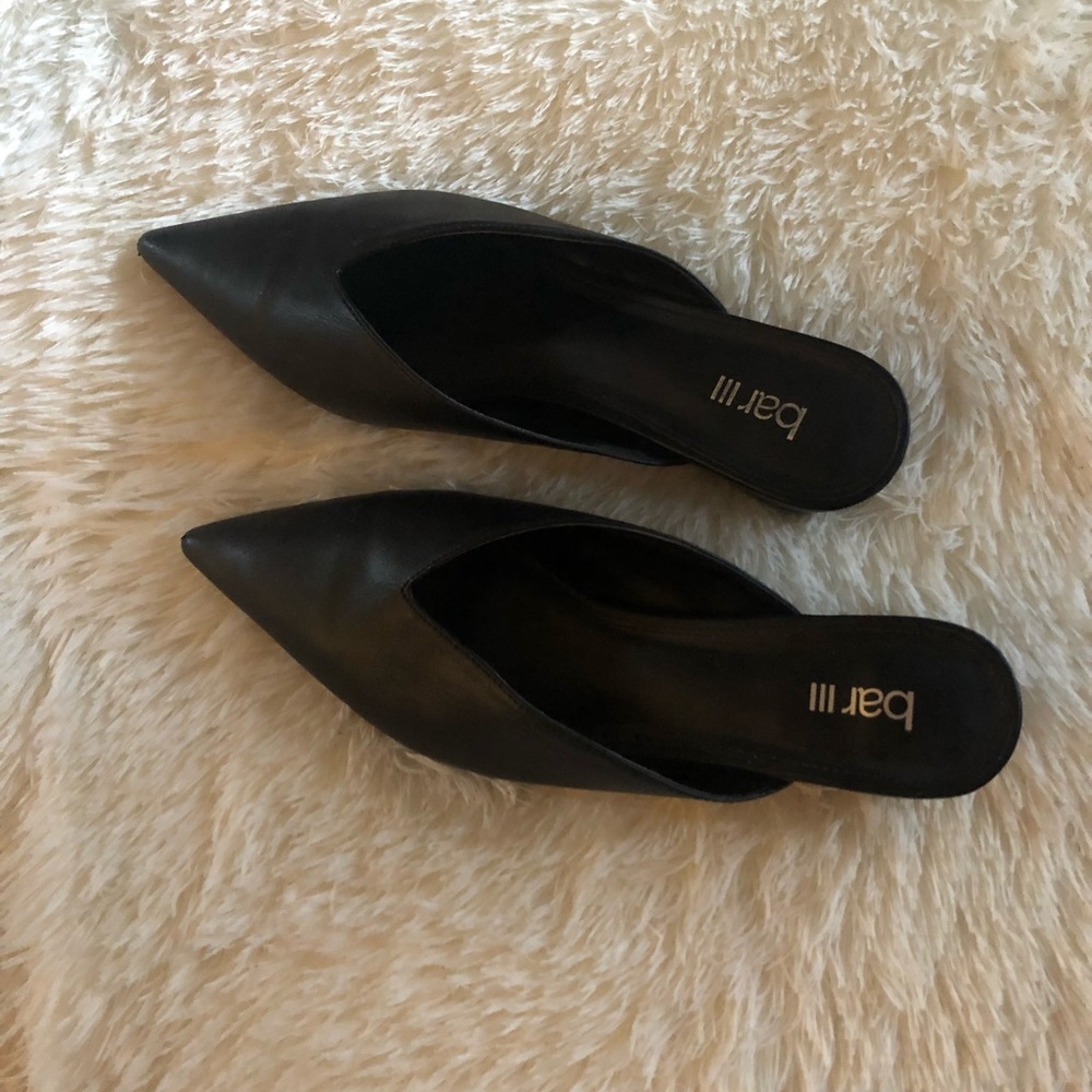 Woman’s black slide on dress shoe.